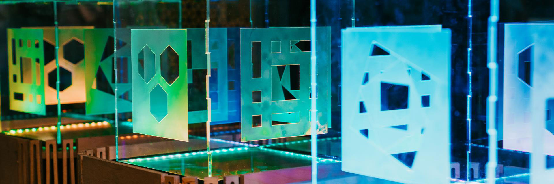 In a colorful public art installation, lasercut plexiglass cubes light up with the five symbols representing the five design behaviors taught in Design Bloc.